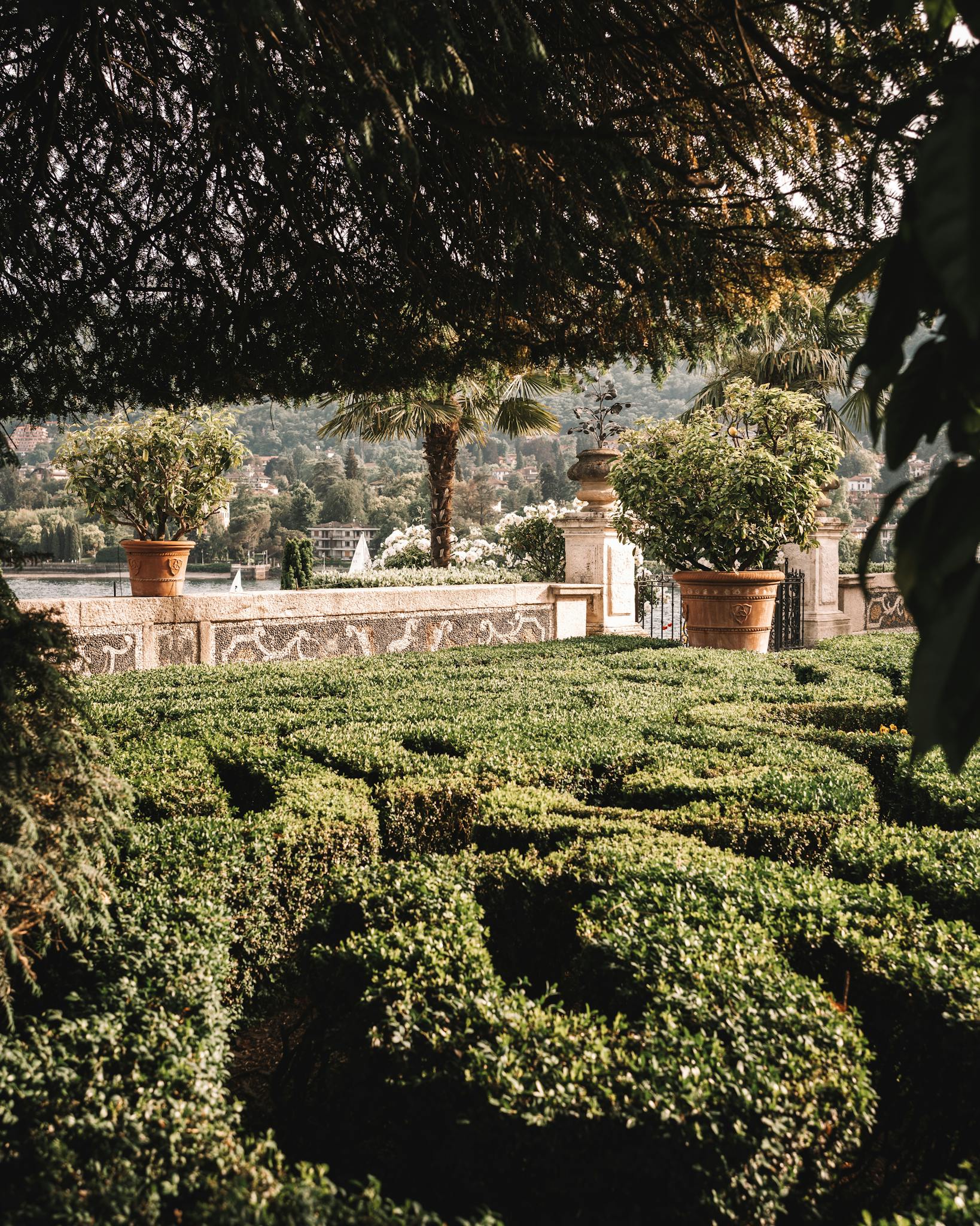 Lush green topiary garden overlooking the scenic Lake Maggiore in summer.